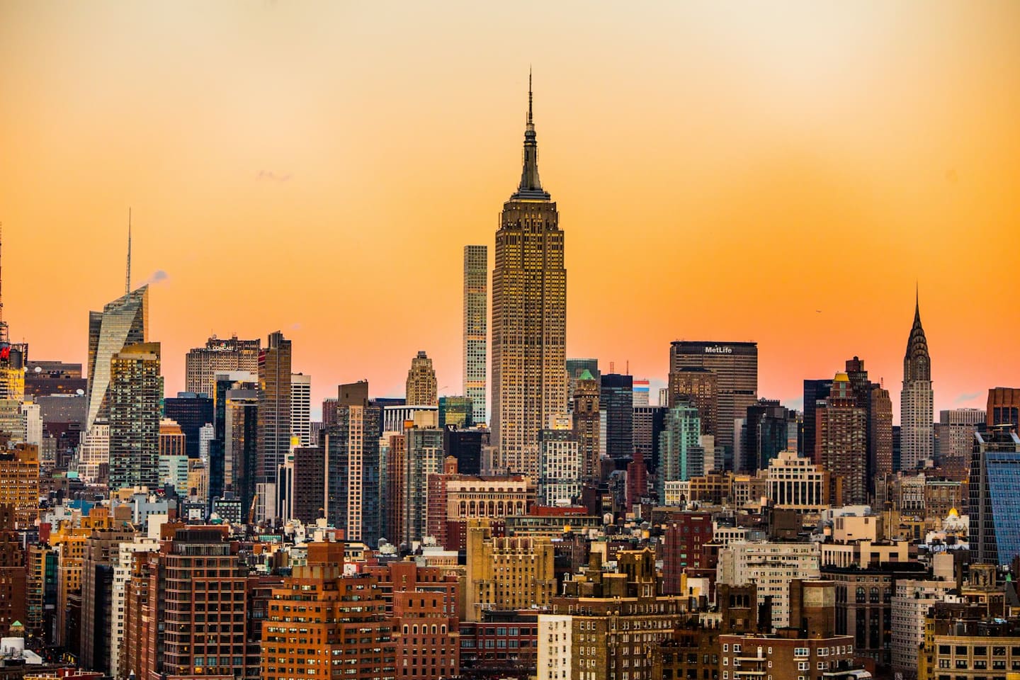 The Empire State Building rising above the Manhattan skyline at golden hour