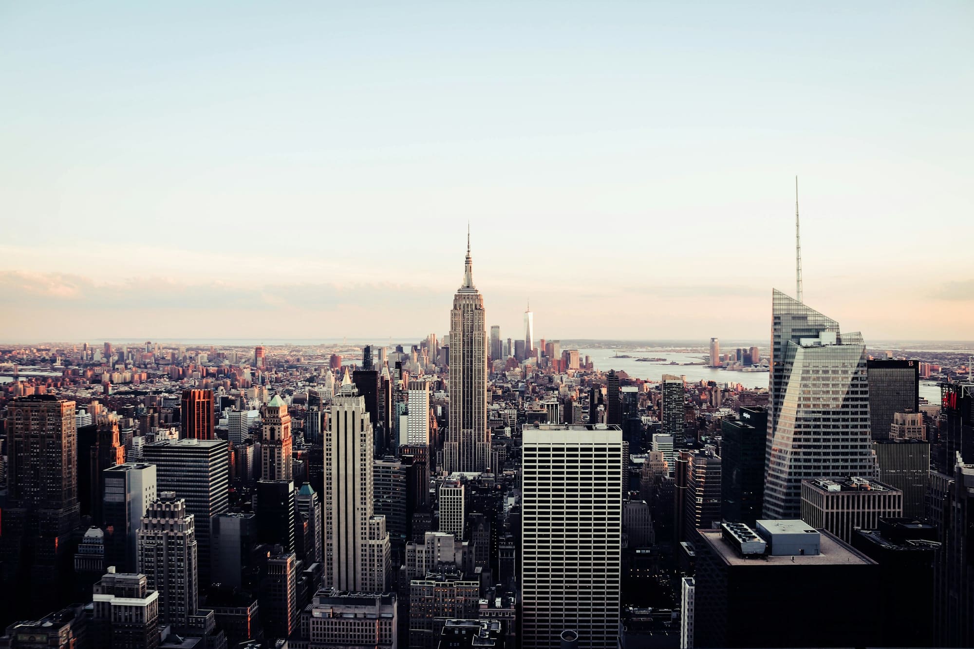 The Manhattan skyline with the Empire State Building under a pale morning sky